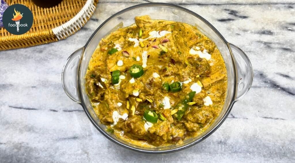 Rich Mughlai beef korma served in a bowl, garnished with pistachios