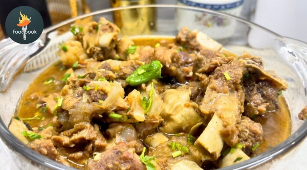 Authentic Peshawari Namkeen Gosht – spicy beef curry in a traditional handi, garnished with coriander and green chilies